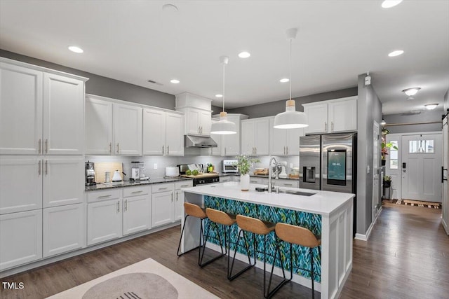 kitchen with white cabinetry, appliances with stainless steel finishes, sink, and pendant lighting