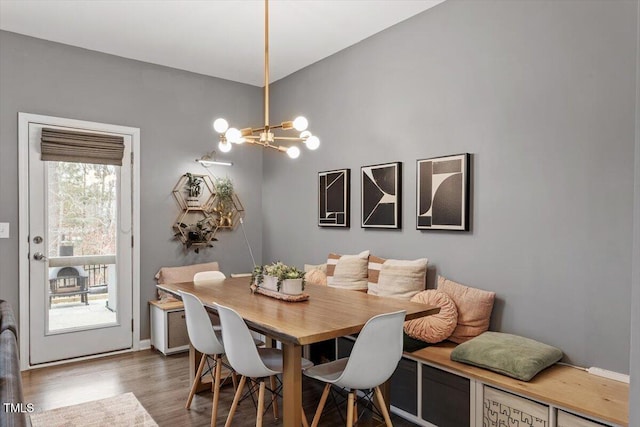 dining area featuring a chandelier and dark hardwood / wood-style flooring