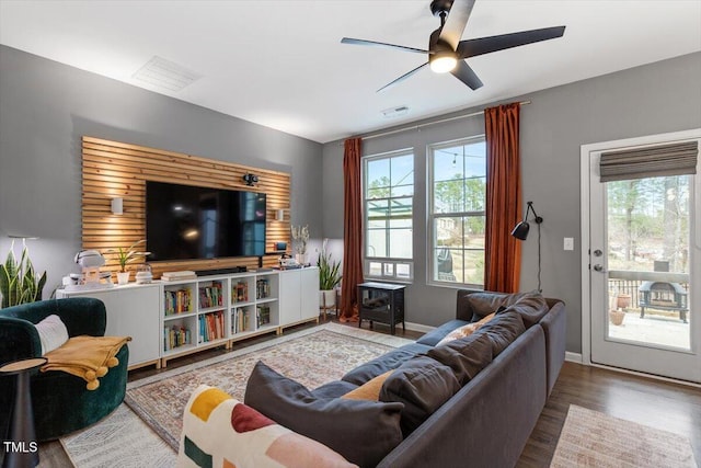 living room with ceiling fan, a wealth of natural light, and wood-type flooring