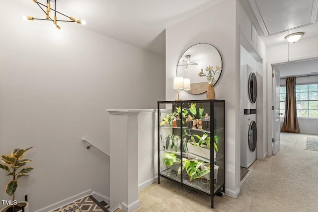 interior space featuring stacked washer / dryer and light carpet