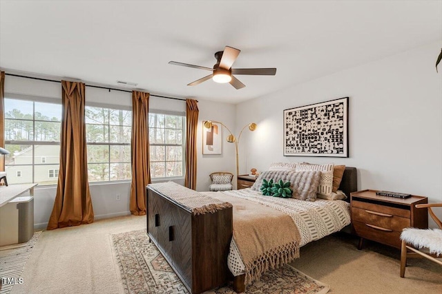 bedroom with ceiling fan and light colored carpet