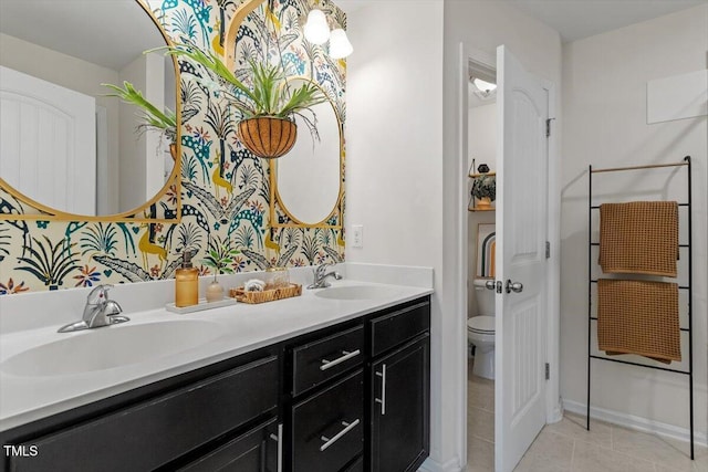 bathroom with vanity, tile patterned flooring, and toilet