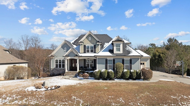 view of front of house with a front yard and stone siding