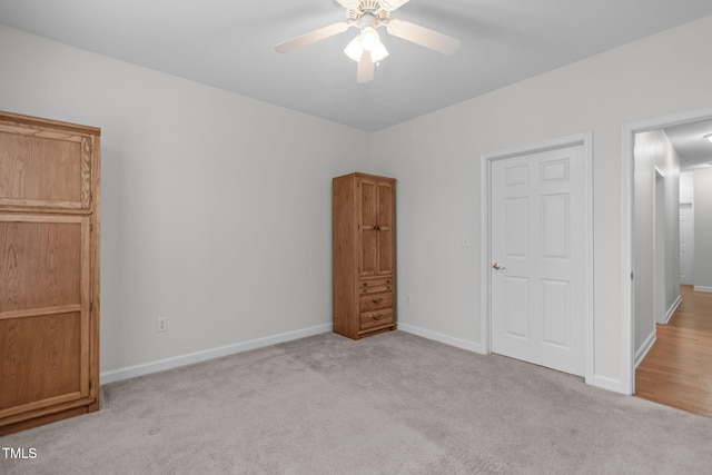 unfurnished bedroom featuring light colored carpet and ceiling fan