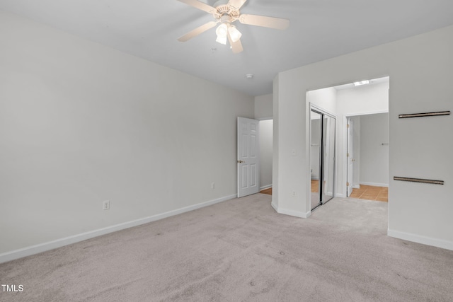 unfurnished bedroom featuring ceiling fan and light colored carpet