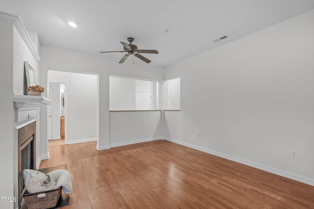 unfurnished living room featuring ceiling fan and light hardwood / wood-style floors