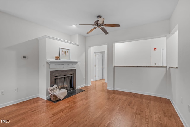 unfurnished living room featuring ceiling fan and light wood-type flooring