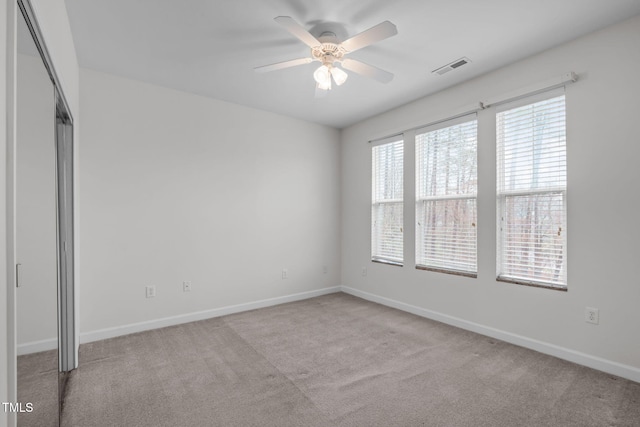 carpeted empty room with ceiling fan
