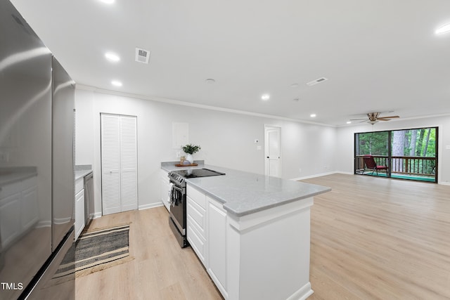 kitchen with black electric range, visible vents, light wood-style flooring, ornamental molding, and freestanding refrigerator