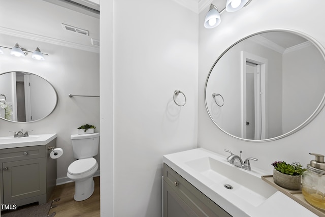 bathroom with two vanities, visible vents, a sink, and toilet