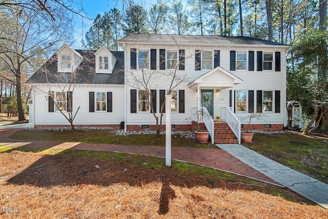 colonial-style house with crawl space and a front lawn