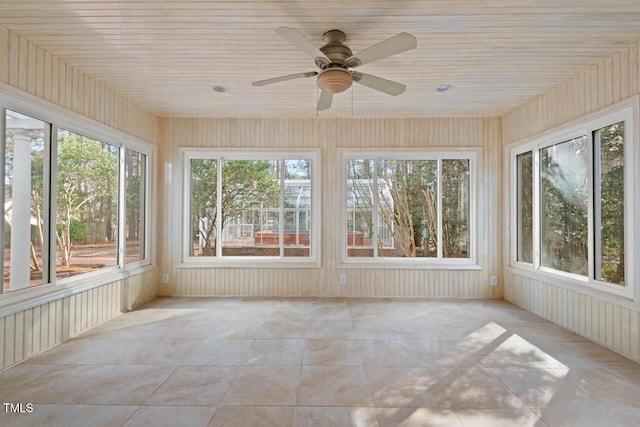 unfurnished sunroom with ceiling fan