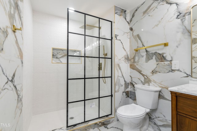 bathroom featuring vanity, tiled shower, and toilet