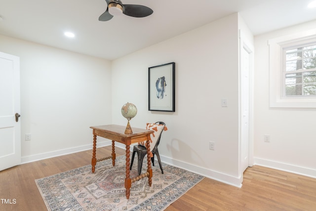 office space with ceiling fan and light hardwood / wood-style floors