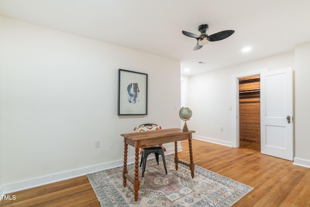 home office featuring ceiling fan and light hardwood / wood-style floors