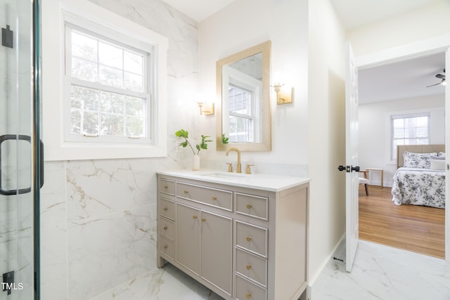 bathroom featuring vanity, an enclosed shower, and tile walls