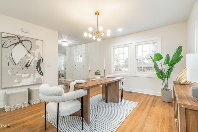 office with an inviting chandelier and light wood-type flooring