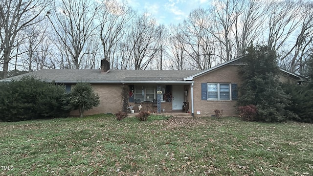 single story home with a porch and a front yard