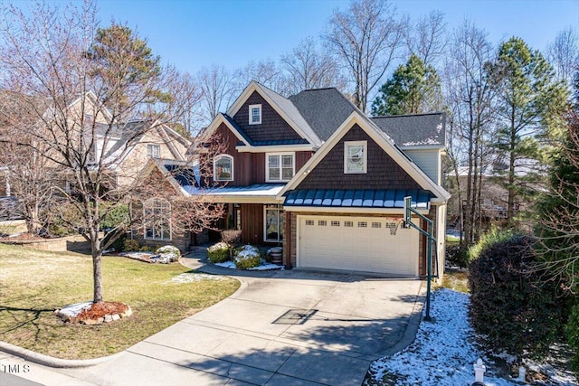 craftsman inspired home featuring a front yard, a standing seam roof, driveway, and metal roof