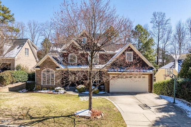 view of front of home with a garage, concrete driveway, and a front lawn