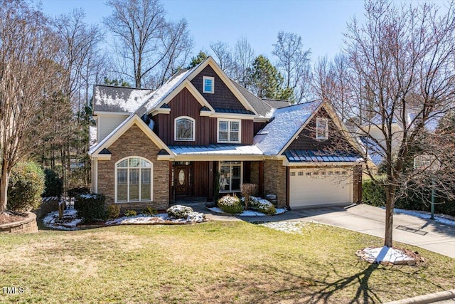 craftsman inspired home featuring an attached garage, driveway, board and batten siding, and a front yard