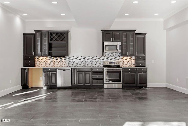 bar with ornamental molding, tasteful backsplash, appliances with stainless steel finishes, and baseboards