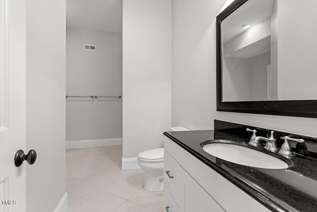 bathroom with visible vents, toilet, vanity, baseboards, and tile patterned floors