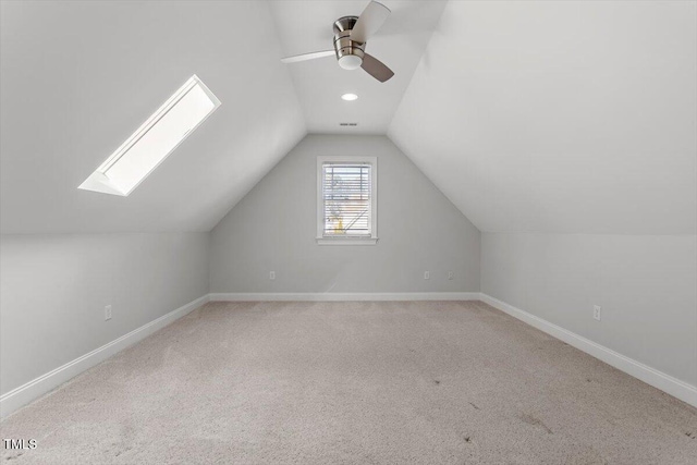 bonus room with lofted ceiling, carpet, baseboards, and a ceiling fan