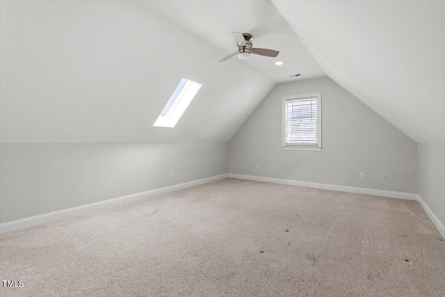 bonus room with ceiling fan, baseboards, vaulted ceiling, and carpet flooring