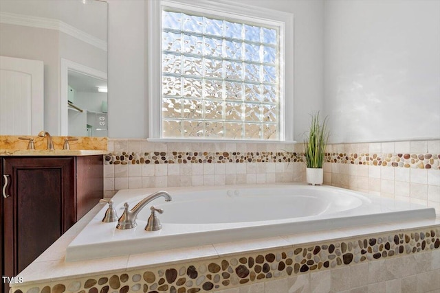 bathroom with a garden tub, crown molding, and vanity