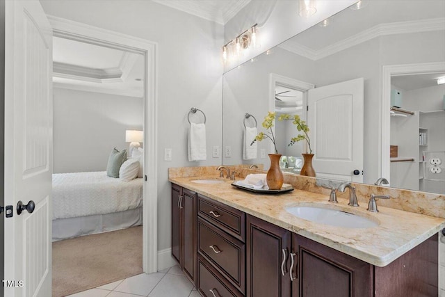 ensuite bathroom with a sink, ornamental molding, and connected bathroom