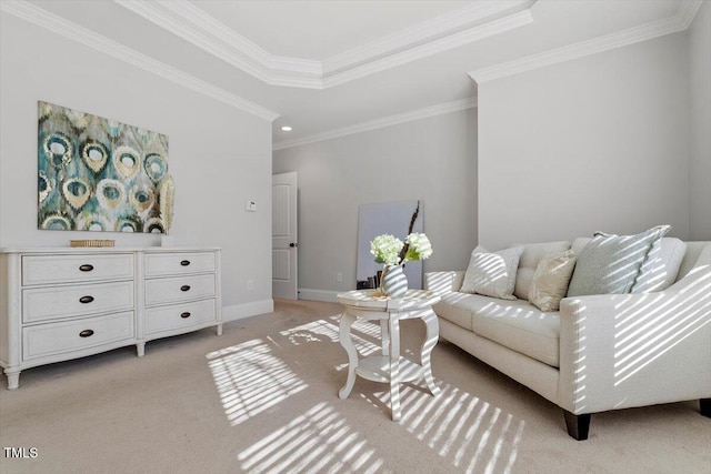 interior space featuring ornamental molding, a raised ceiling, light colored carpet, and baseboards