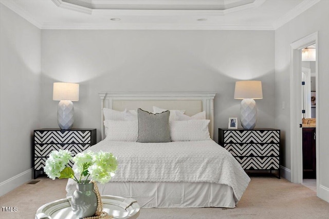 bedroom with ornamental molding, a tray ceiling, light colored carpet, and baseboards