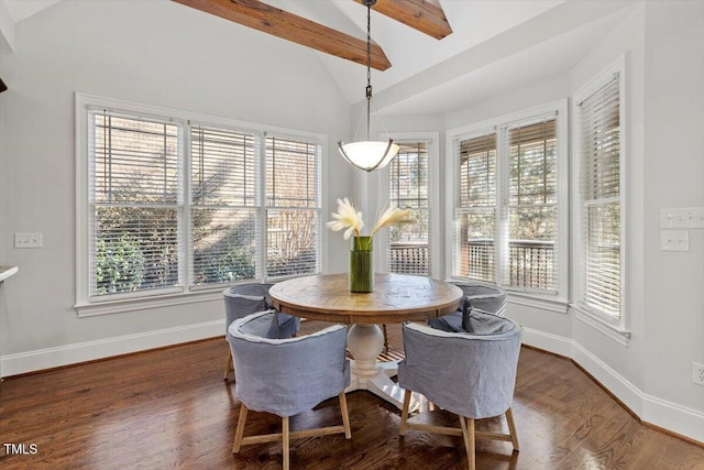 dining room featuring vaulted ceiling with beams, dark wood-style floors, a wealth of natural light, and baseboards