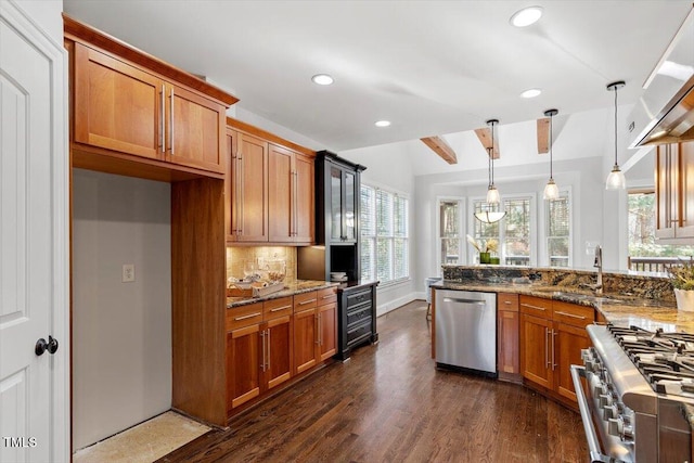 kitchen featuring stone counters, brown cabinets, stainless steel appliances, hanging light fixtures, and backsplash