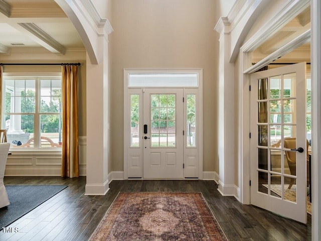 entryway with crown molding, baseboards, dark wood-type flooring, and beamed ceiling