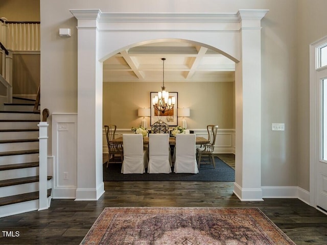 dining space with a notable chandelier, dark wood-style flooring, coffered ceiling, stairway, and beamed ceiling