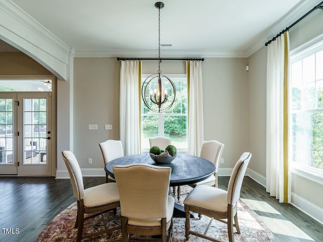 dining space featuring crown molding, arched walkways, a notable chandelier, and wood finished floors