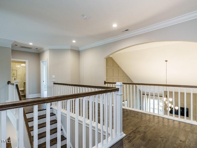 hall with a chandelier, ornamental molding, dark wood finished floors, and recessed lighting