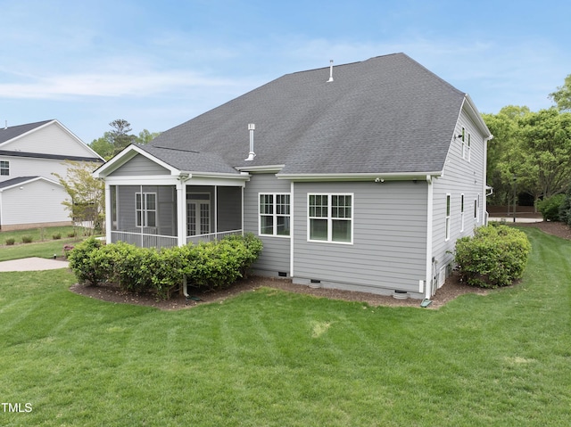 rear view of house featuring a sunroom, crawl space, roof with shingles, and a lawn