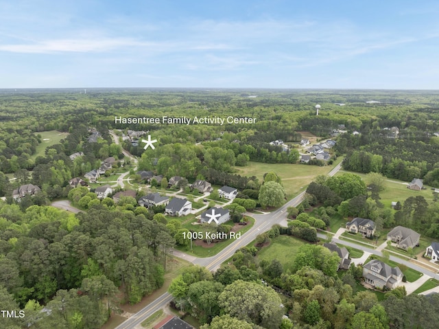 aerial view featuring a forest view and a residential view