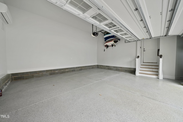 garage with a garage door opener and a wall unit AC