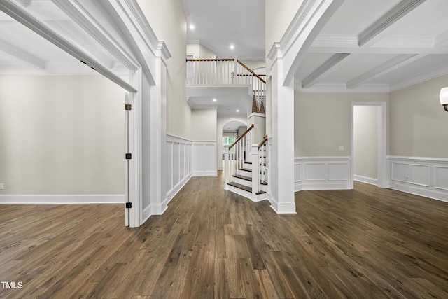 entrance foyer with arched walkways, beamed ceiling, wood finished floors, stairway, and crown molding