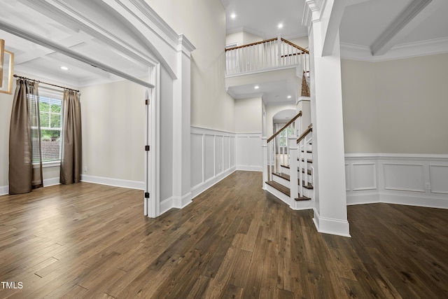 entryway featuring hardwood / wood-style floors, stairway, and ornamental molding