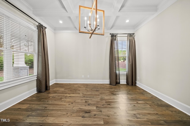 empty room featuring an inviting chandelier, ornamental molding, and coffered ceiling