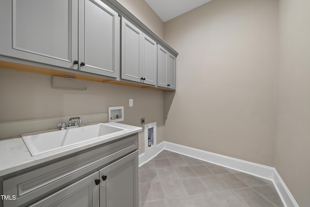 washroom with hookup for a washing machine, a sink, electric dryer hookup, cabinet space, and baseboards