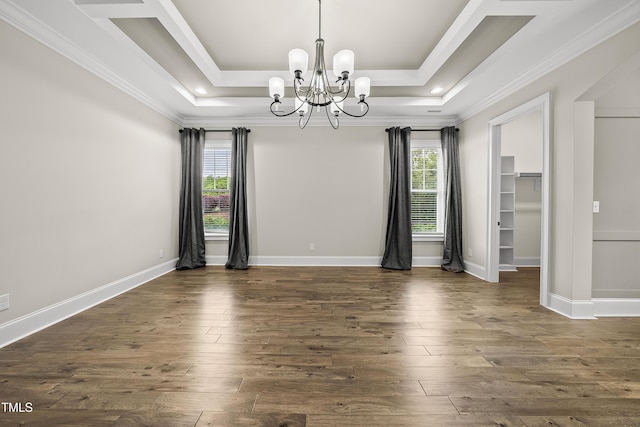 spare room with a chandelier, dark wood-style floors, and plenty of natural light