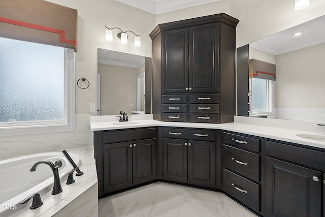 bathroom with marble finish floor, a bath, crown molding, and vanity