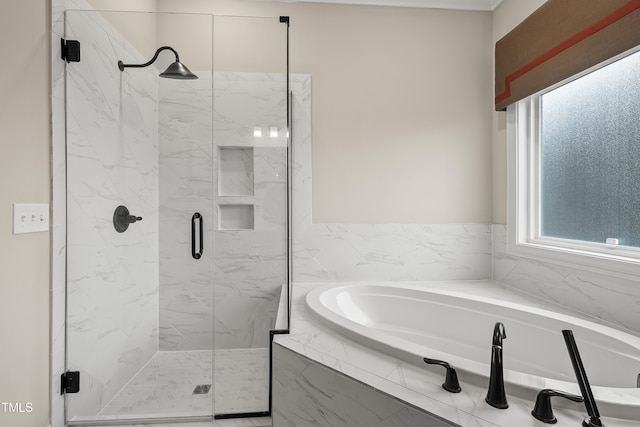 full bathroom with a garden tub, a marble finish shower, and plenty of natural light