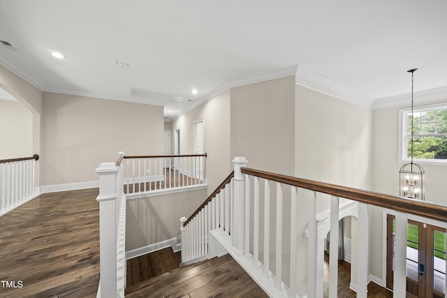 stairway with wood finished floors, recessed lighting, a notable chandelier, and ornamental molding